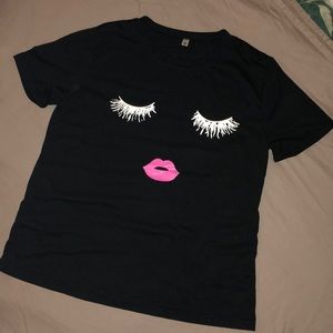 Black T-shirt with sleeping face design.